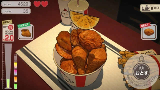 爆盛食堂のゲーム画面。バケツ入りのフライドチキンとオレンジを積み上げている