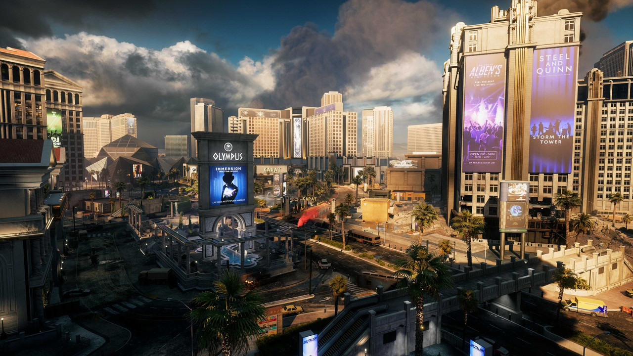 『Battlefield 6』新マップ「Vegas Strip」のスクリーンショット。「OLYMPUS」の看板塔とヤシの木が並ぶ大通りの奥に高層ホテル群が建ち、上空に黒煙が上がる